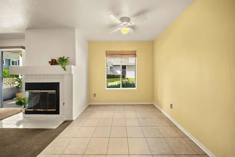 a view of a livingroom with a fireplace and window