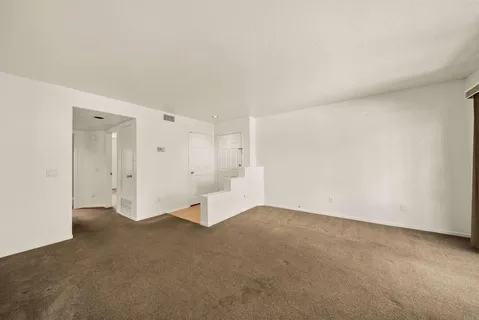 a bedroom with a bed and windows