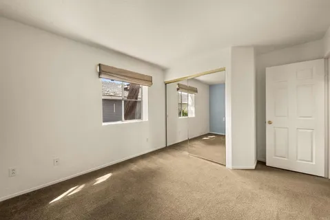 a bathroom with a granite countertop sink a toilet a mirror and shower