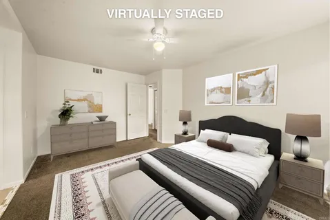 a bedroom with a large bed and a chandelier