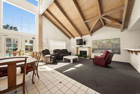 a view of a patio with dining table and chairs