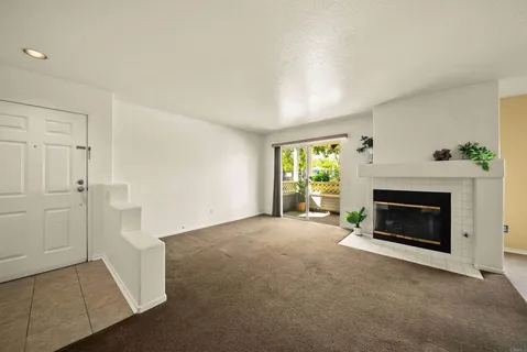 a view of a livingroom with an empty space and a fireplace