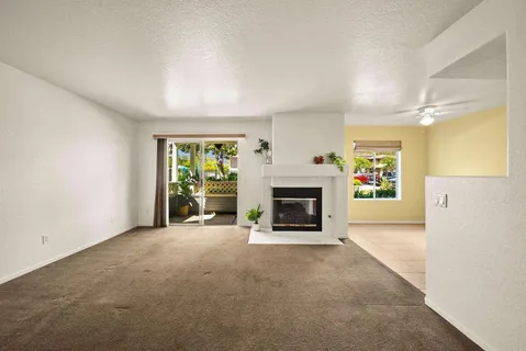 an empty room with furniture and a fireplace