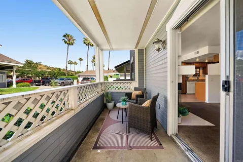 a balcony with furniture and potted plants