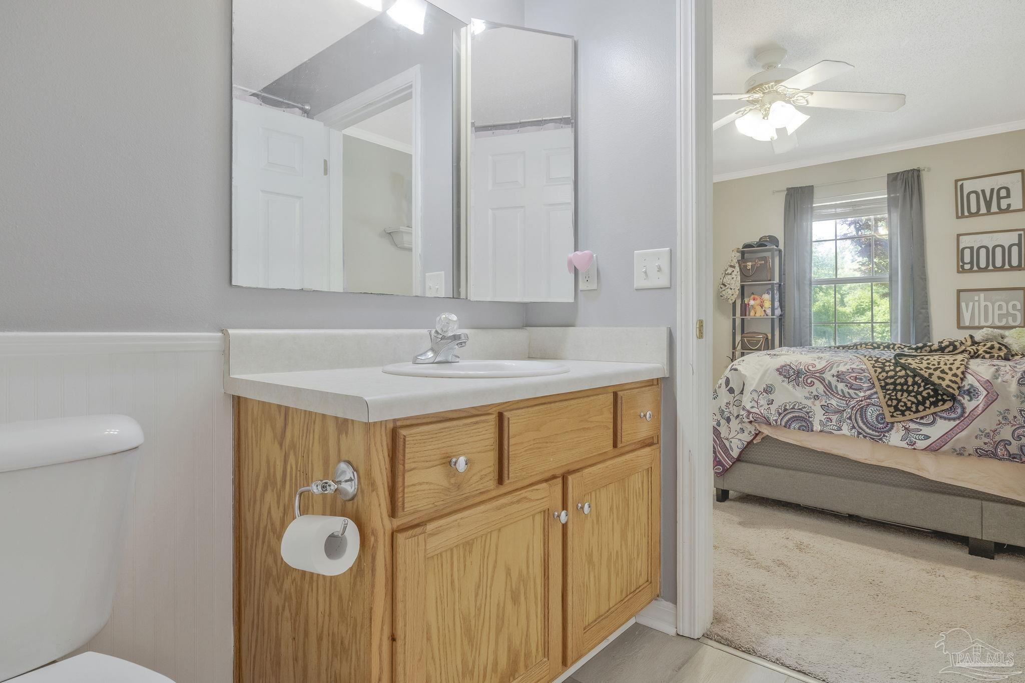5539 Windrun Place Pace, FL 32571 - Photo 30 of 62 a en suite bathroom with a sink and a mirror