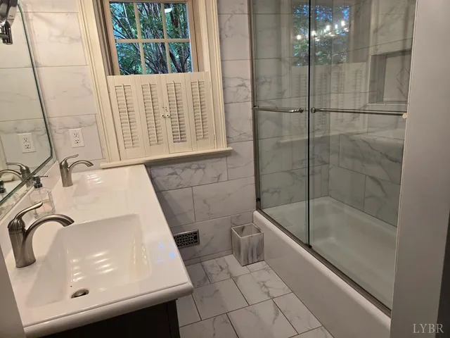 a bathroom with a sink a bathtub and a shower