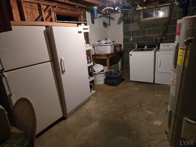 a view of storage and utility room with refrigerator and washer