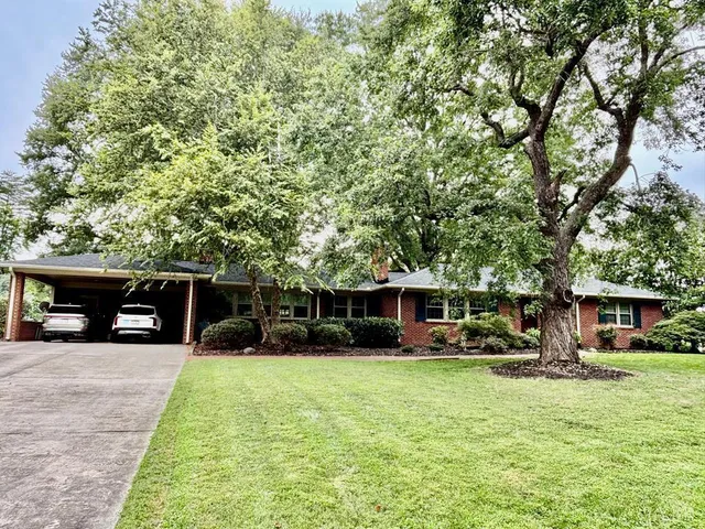 a view of a house with a yard patio and a slide