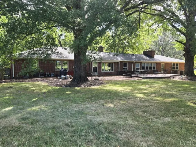 front view of a house with a yard patio and swimming pool