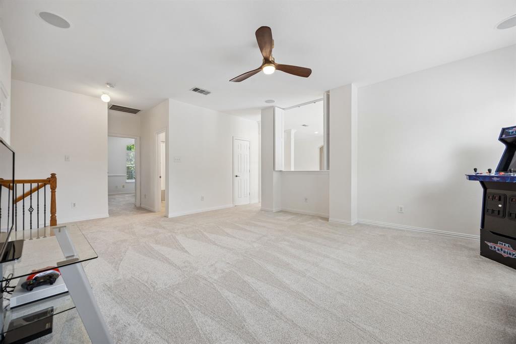 5808 Rathbone Drive Parker, TX 75002 - Photo 26 of 39 The second floor living space has carpet, ceiling fan and is partially open to the second floor adding to the open feel of the space.