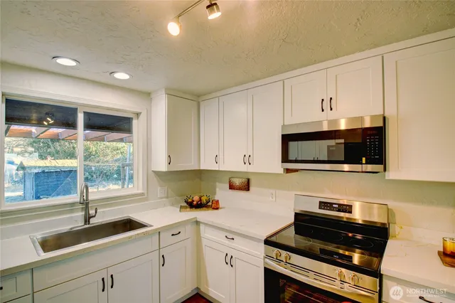 a dining room with wooden floor a chandelier a wooden table and chairs