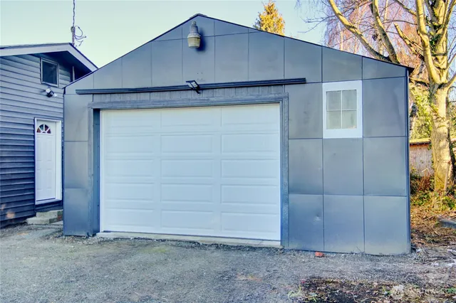 a view of a garage with wooden chairs