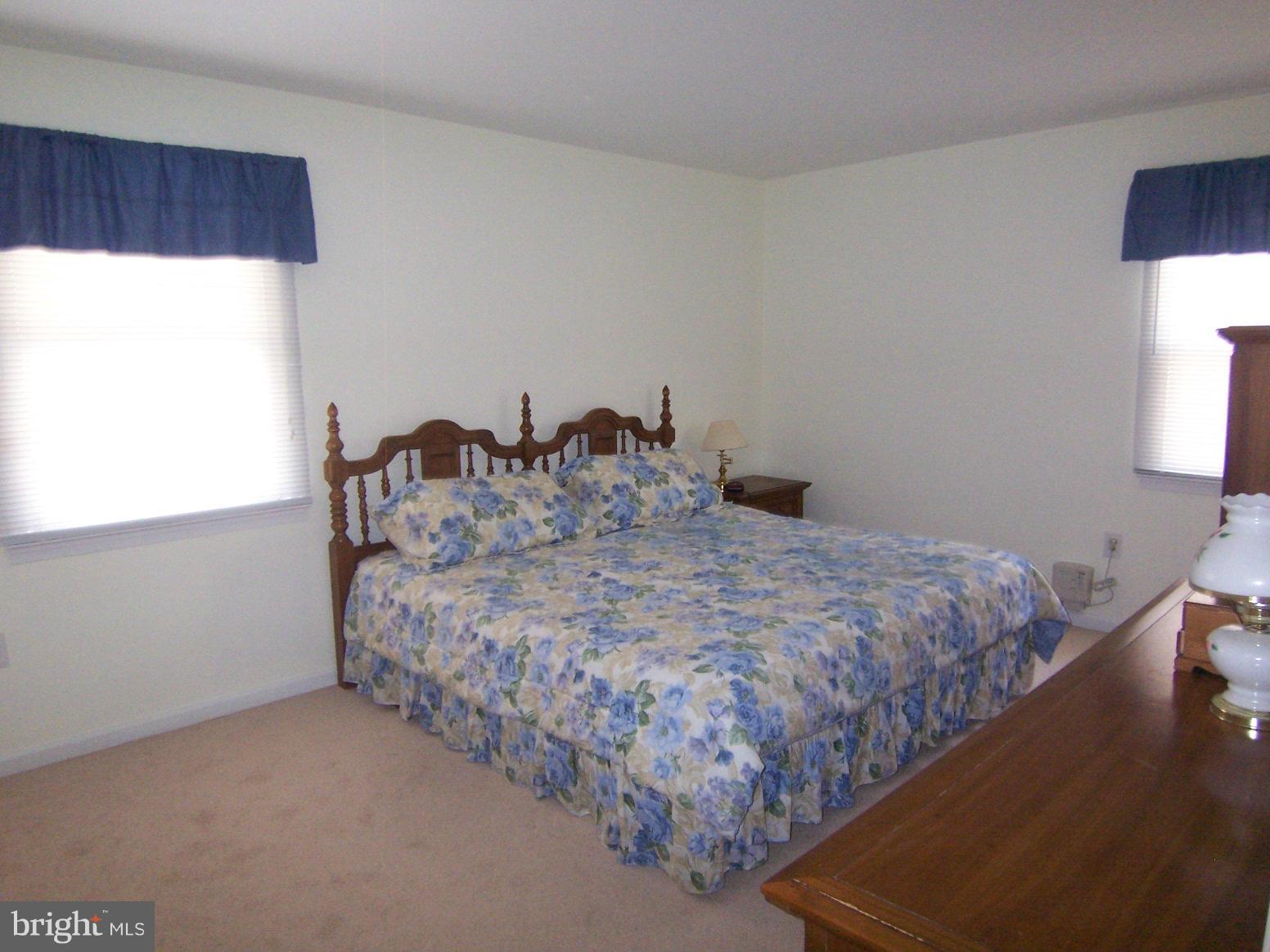 9104 Rookings Court Springfield, VA 22153 - Photo 12 of 22 a bed sitting in a bedroom next to a window