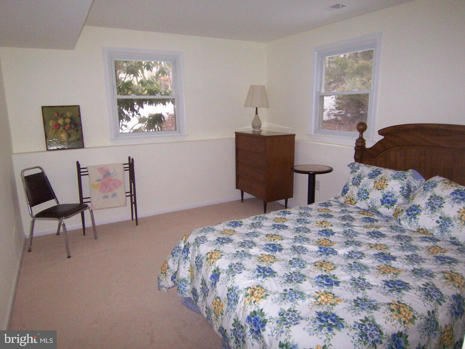 9104 Rookings Court Springfield, VA 22153 - Photo 18 of 22 a bedroom with a bed and a chair in it