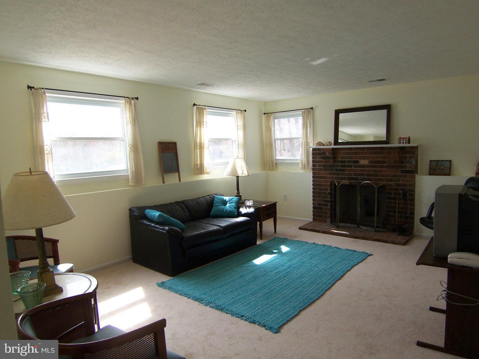 9104 Rookings Court Springfield, VA 22153 - Photo 20 of 22 a living room with furniture and a fireplace