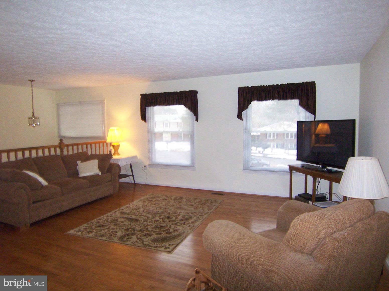 9104 Rookings Court Springfield, VA 22153 - Photo 3 of 22 a living room with furniture a window and a flat screen tv