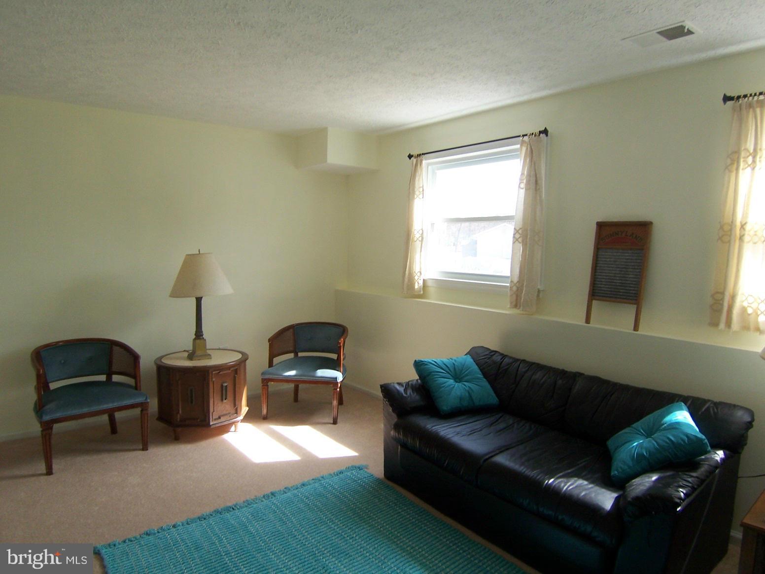 9104 Rookings Court Springfield, VA 22153 - Photo 21 of 22 a living room with furniture and a window