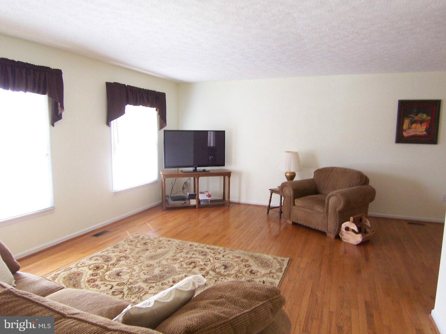 9104 Rookings Court Springfield, VA 22153 - Photo 4 of 22 a living room with furniture and a rug