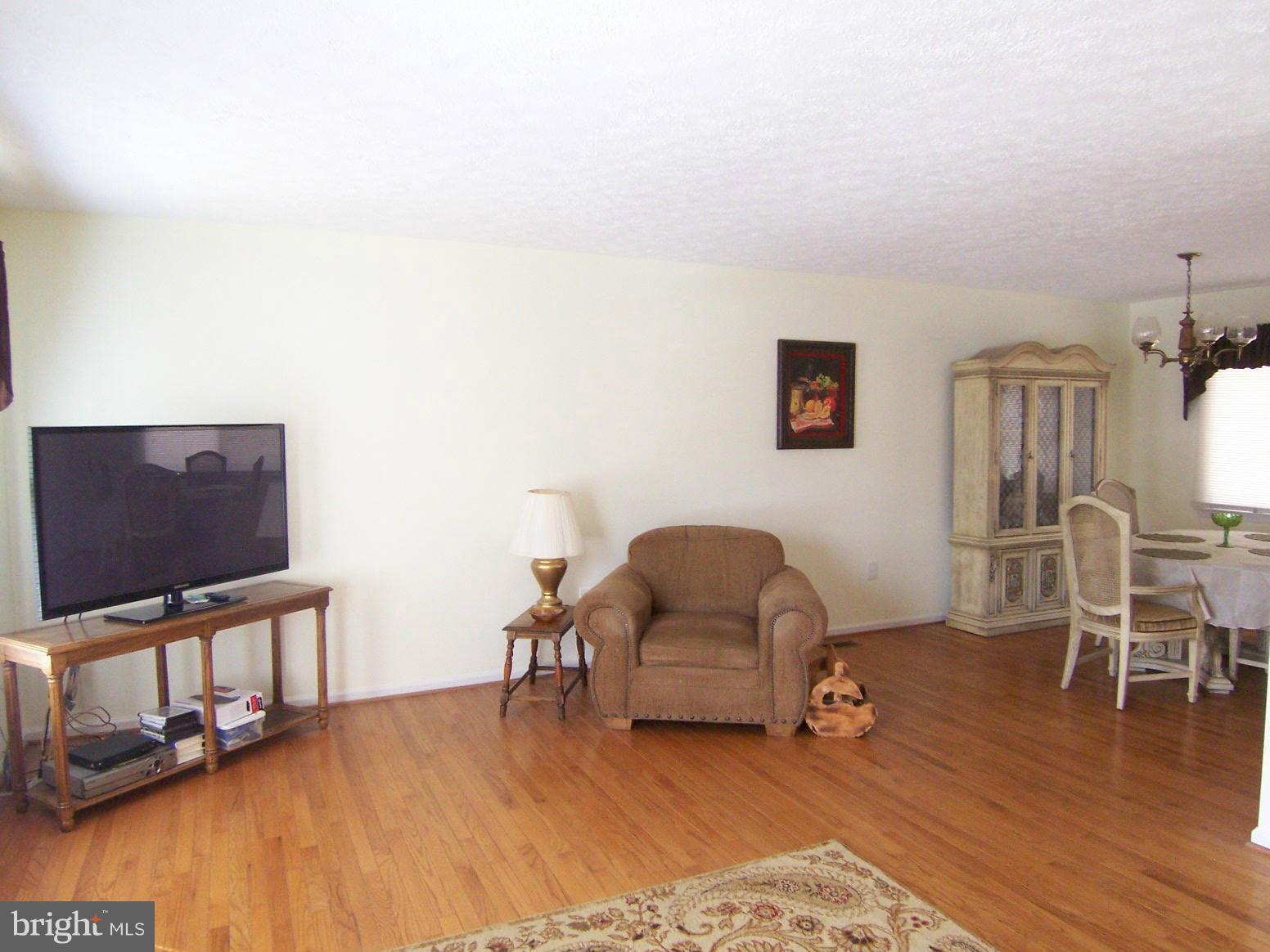 9104 Rookings Court Springfield, VA 22153 - Photo 5 of 22 a living room with furniture and a flat screen tv