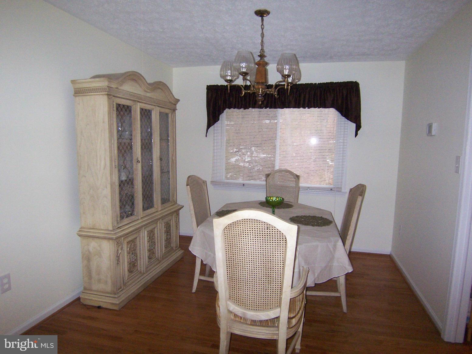 9104 Rookings Court Springfield, VA 22153 - Photo 6 of 22 a view of a dining room with furniture and wooden floor