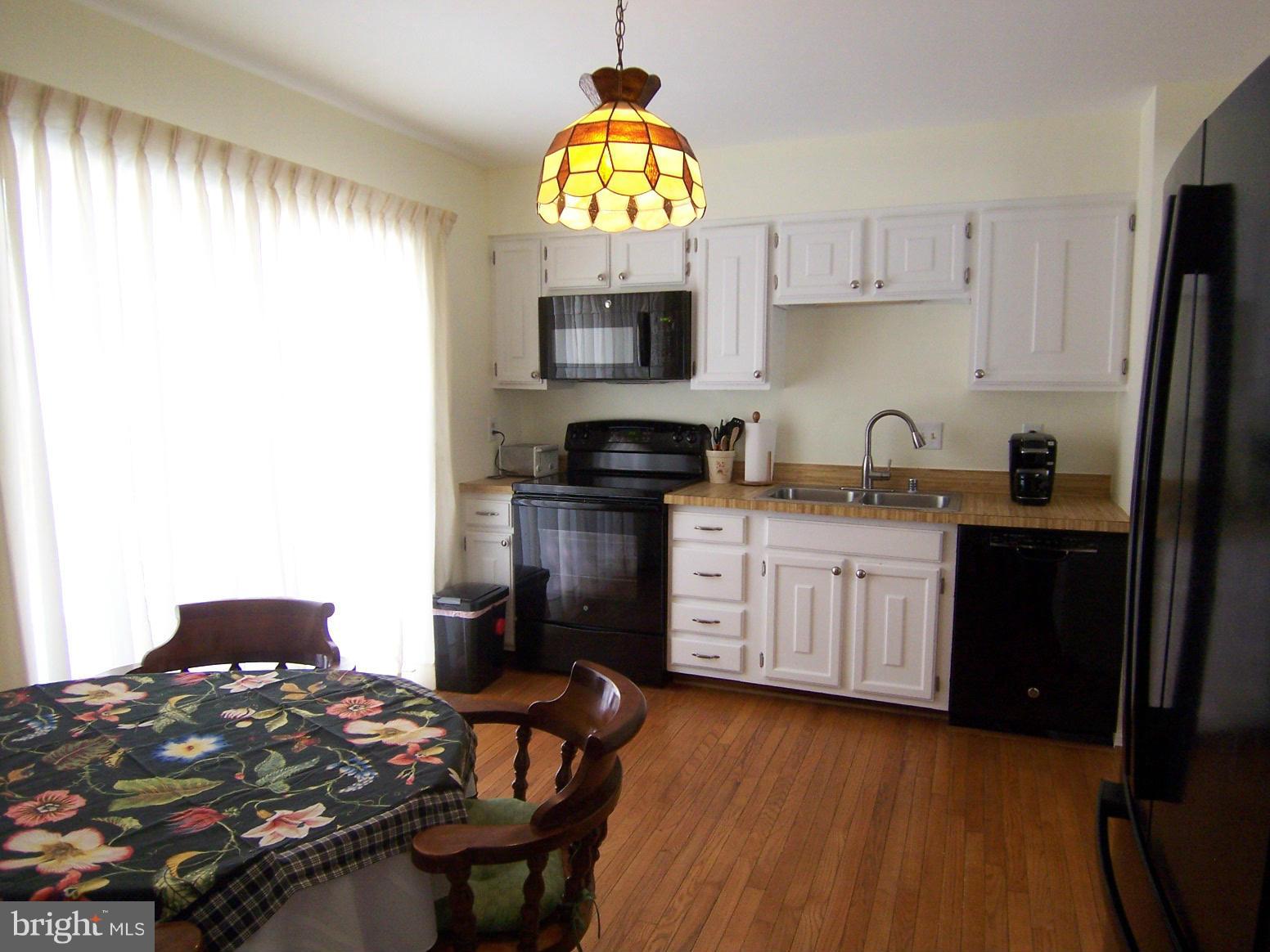 9104 Rookings Court Springfield, VA 22153 - Photo 7 of 22 a kitchen with a sink appliances and cabinets
