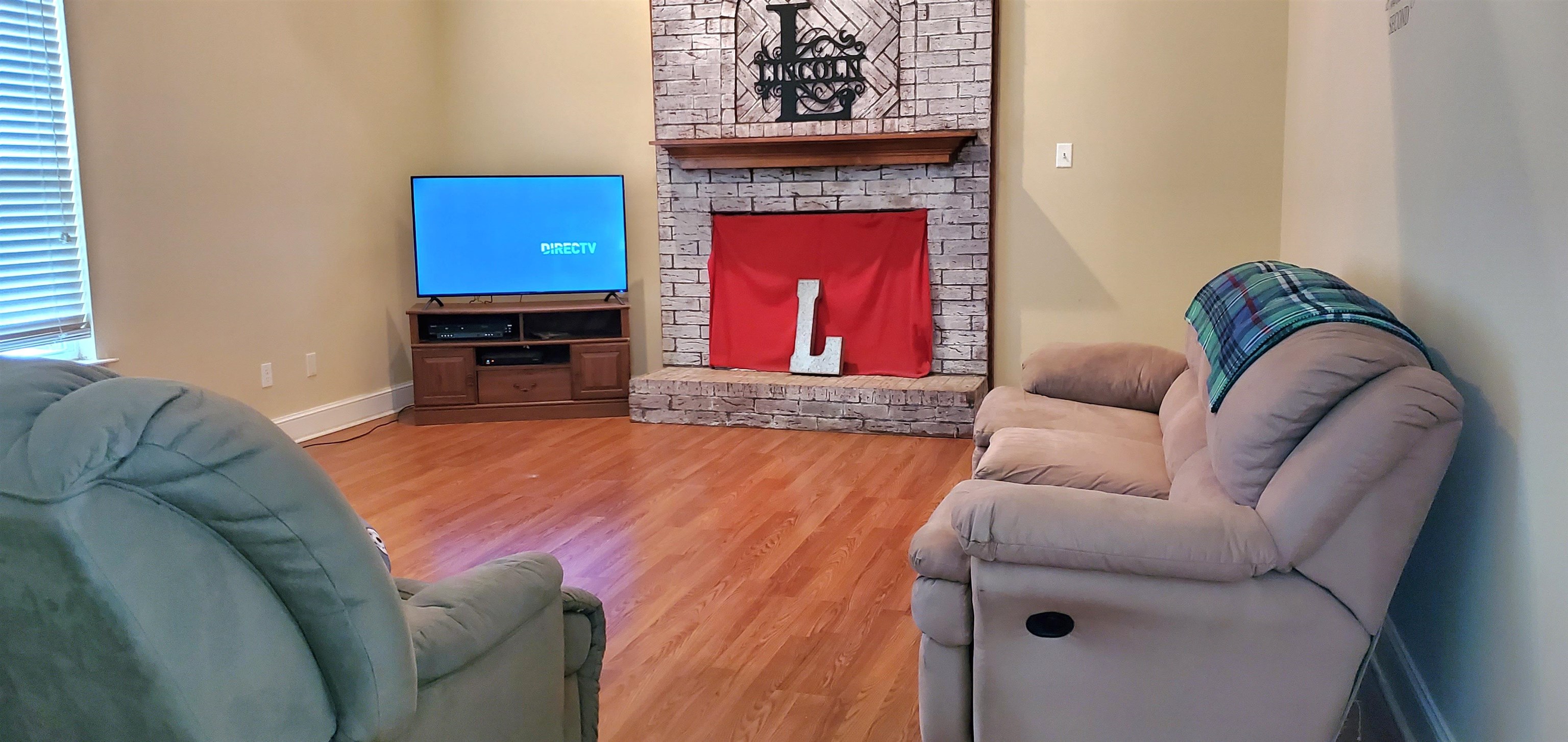 110 R W Anderson Road Mason, TN 38049 - Photo 8 of 23 a living room with furniture and a fireplace