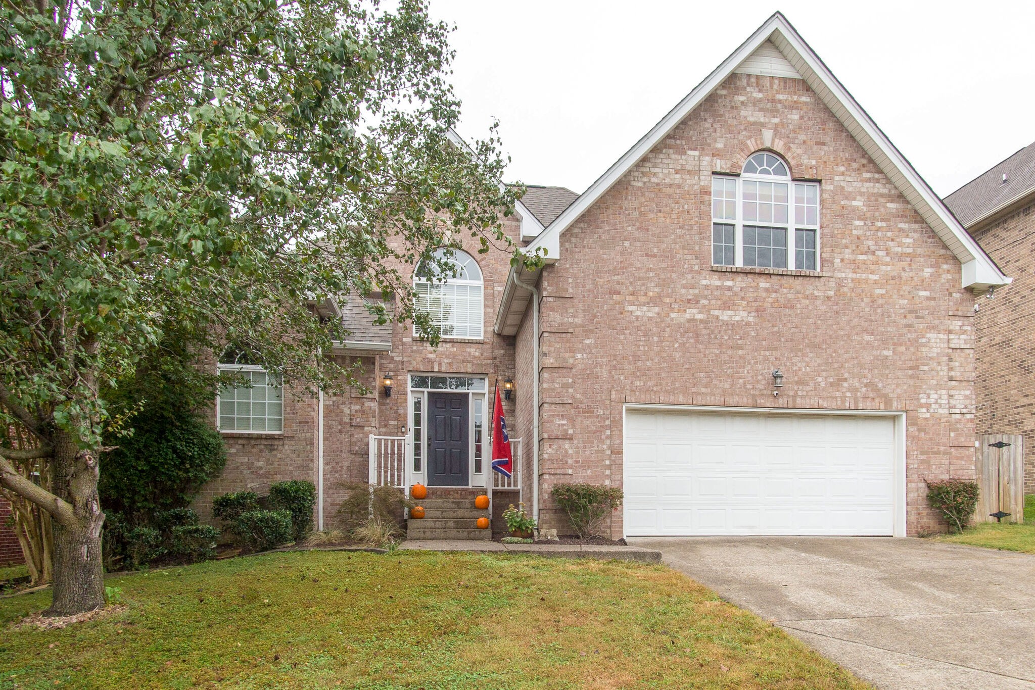 7020 Red Apple Road Antioch, TN 37013 - Photo 1 of 28 a front view of a house with a yard and garage