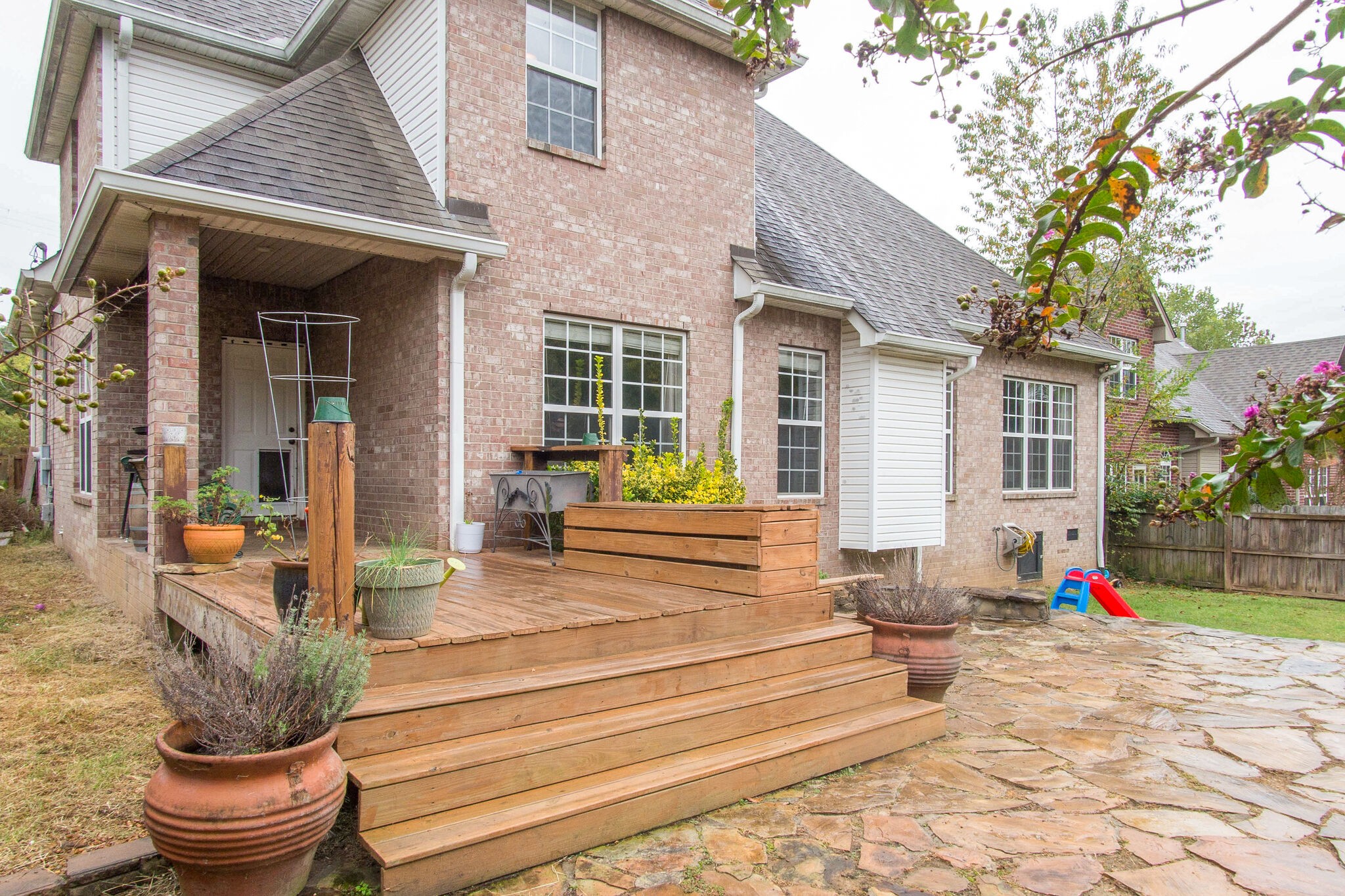 7020 Red Apple Road Antioch, TN 37013 - Photo 26 of 28 a front view of a house with outdoor seating and plants