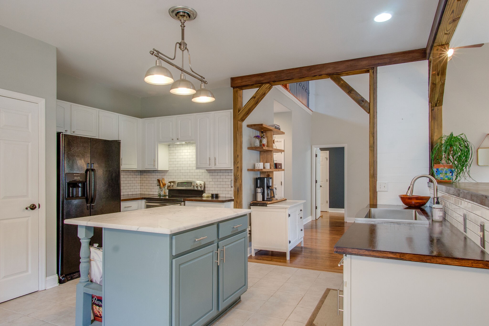 7020 Red Apple Road Antioch, TN 37013 - Photo 9 of 28 a kitchen view with living room a stove and a refrigerator