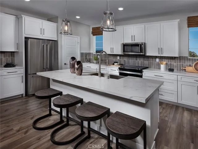 a kitchen with sink cabinets and wooden floor
