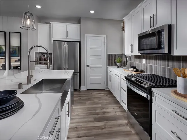 a kitchen with a sink stove and refrigerator