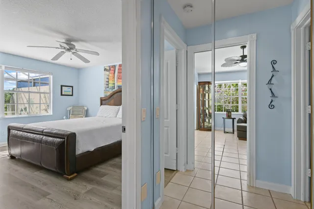 a spacious bedroom with a bed and a chandelier