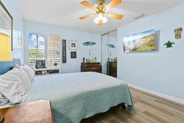 a backyard of a house with basket ball court tables and chairs