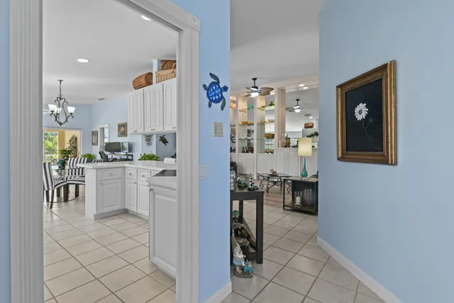 a kitchen with white cabinets and refrigerator