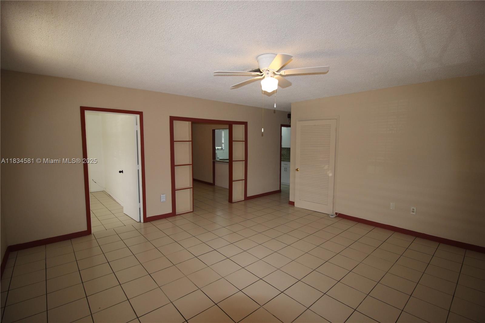 2216 Southwest 62nd Avenue Miami, FL 33155 - Photo 2 of 14 an empty room with closet and fan