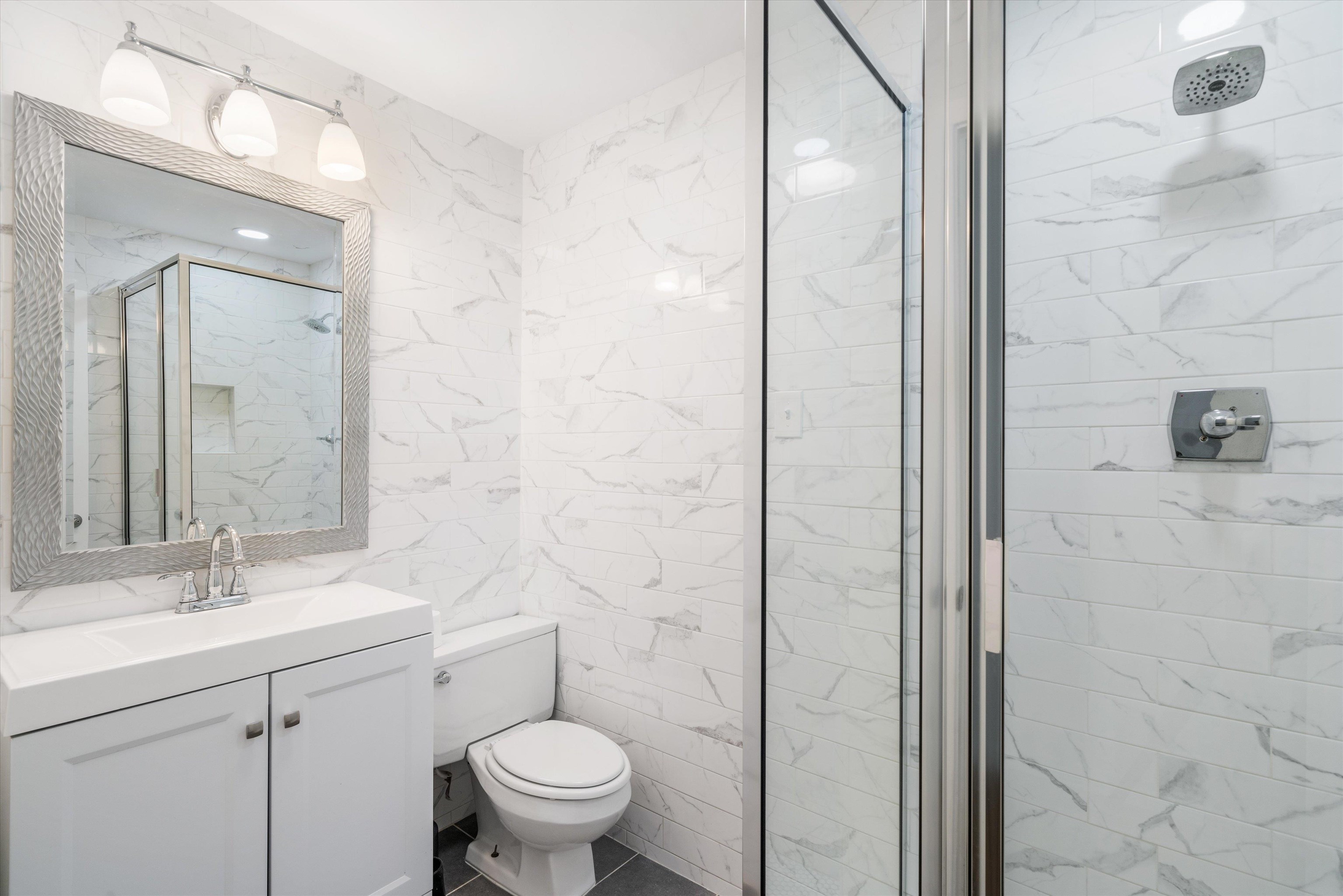 5420 Walnut Grove Road Memphis, TN 38120 - Photo 16 of 25 a bathroom with a sink a toilet and shower