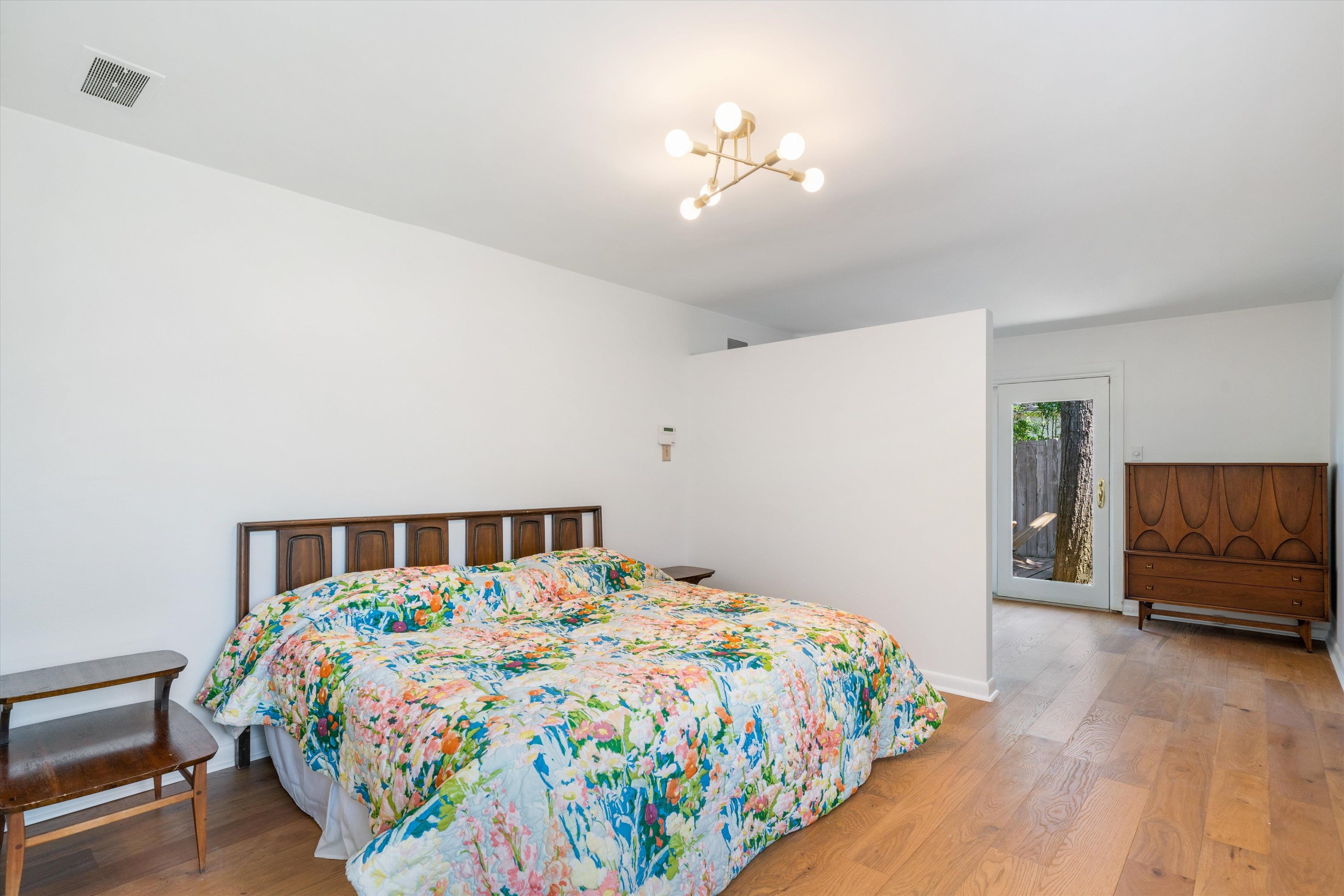 5420 Walnut Grove Road Memphis, TN 38120 - Photo 18 of 25 a bedroom with a bed and wooden floor