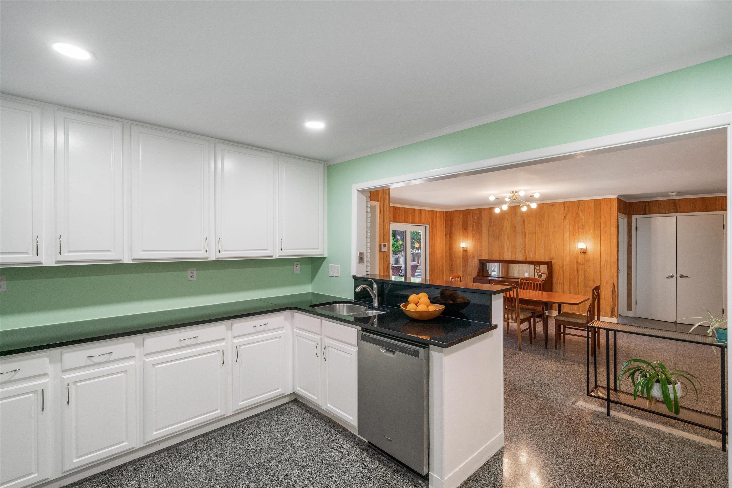 5420 Walnut Grove Road Memphis, TN 38120 - Photo 10 of 25 a kitchen that has a sink and a stove with white cabinets