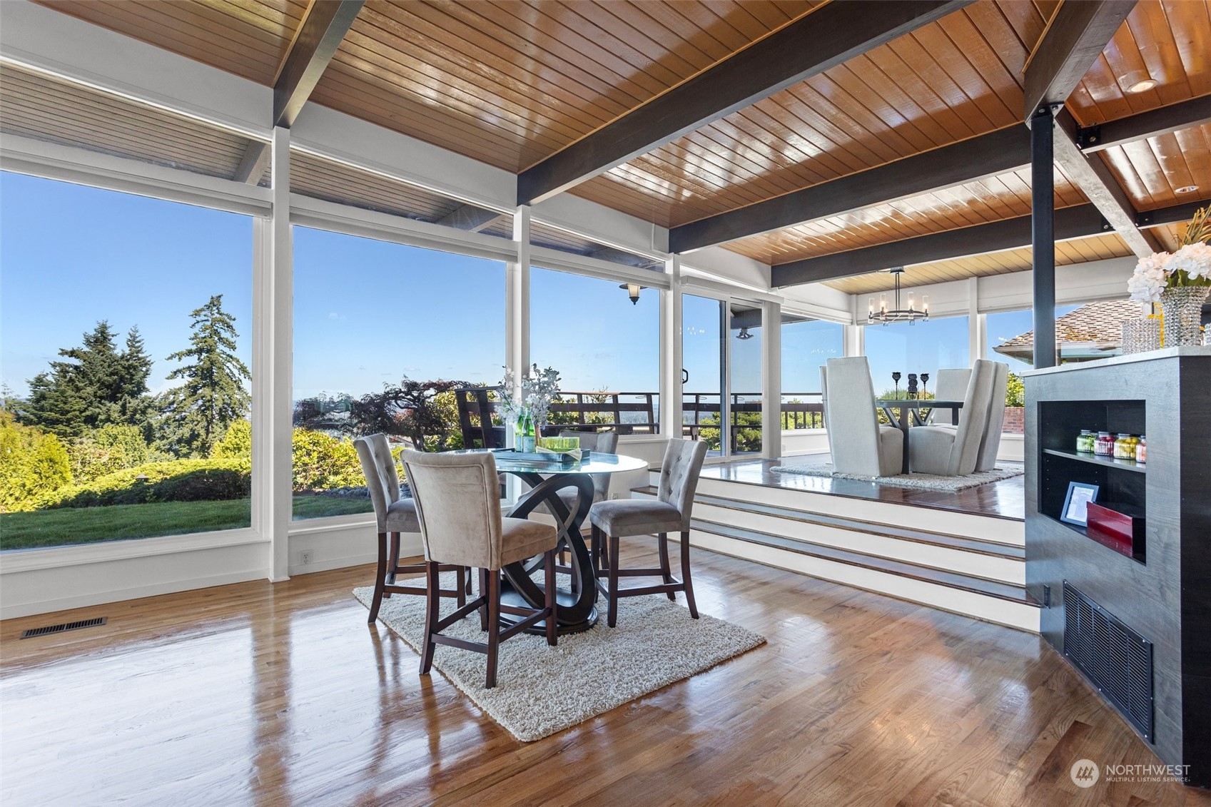 4428 140th Avenue Southeast Bellevue, WA 98006 - Photo 20 of 40 a dining room with furniture floor to ceiling window and outdoor view
