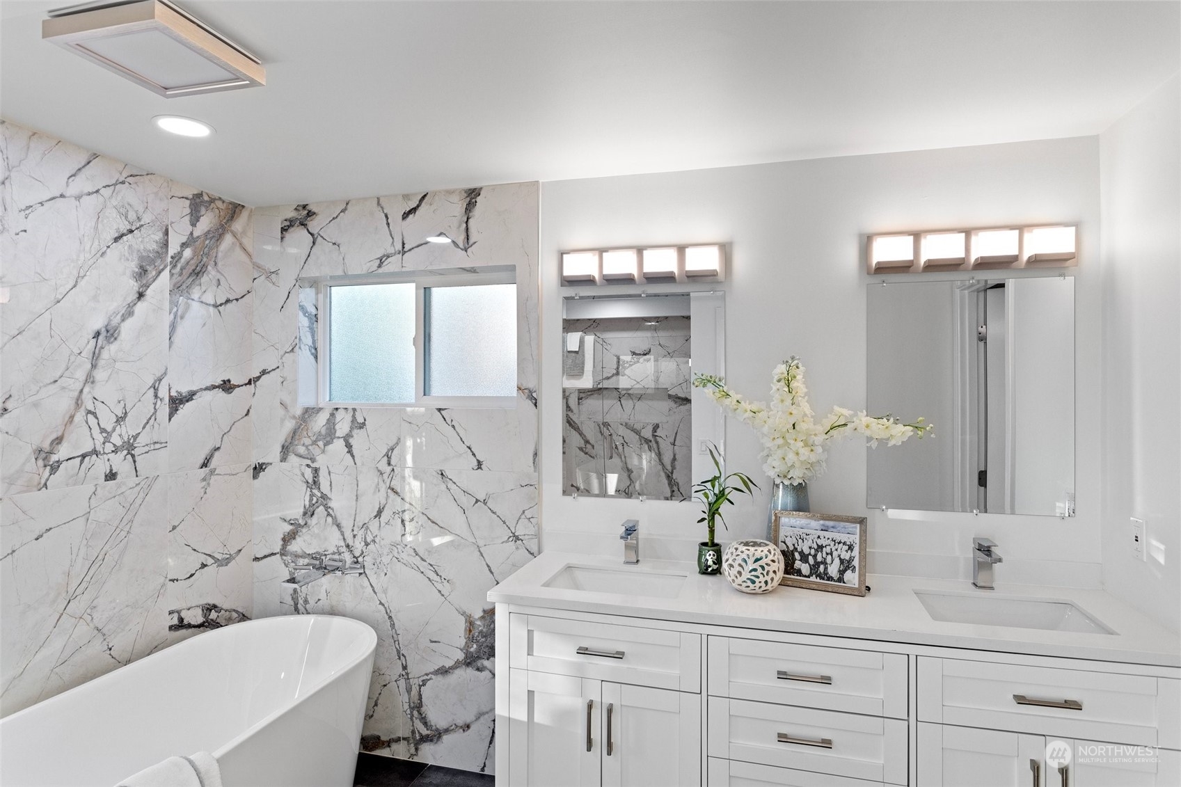 4428 140th Avenue Southeast Bellevue, WA 98006 - Photo 26 of 40 a bathroom with a bathtub sink and mirror
