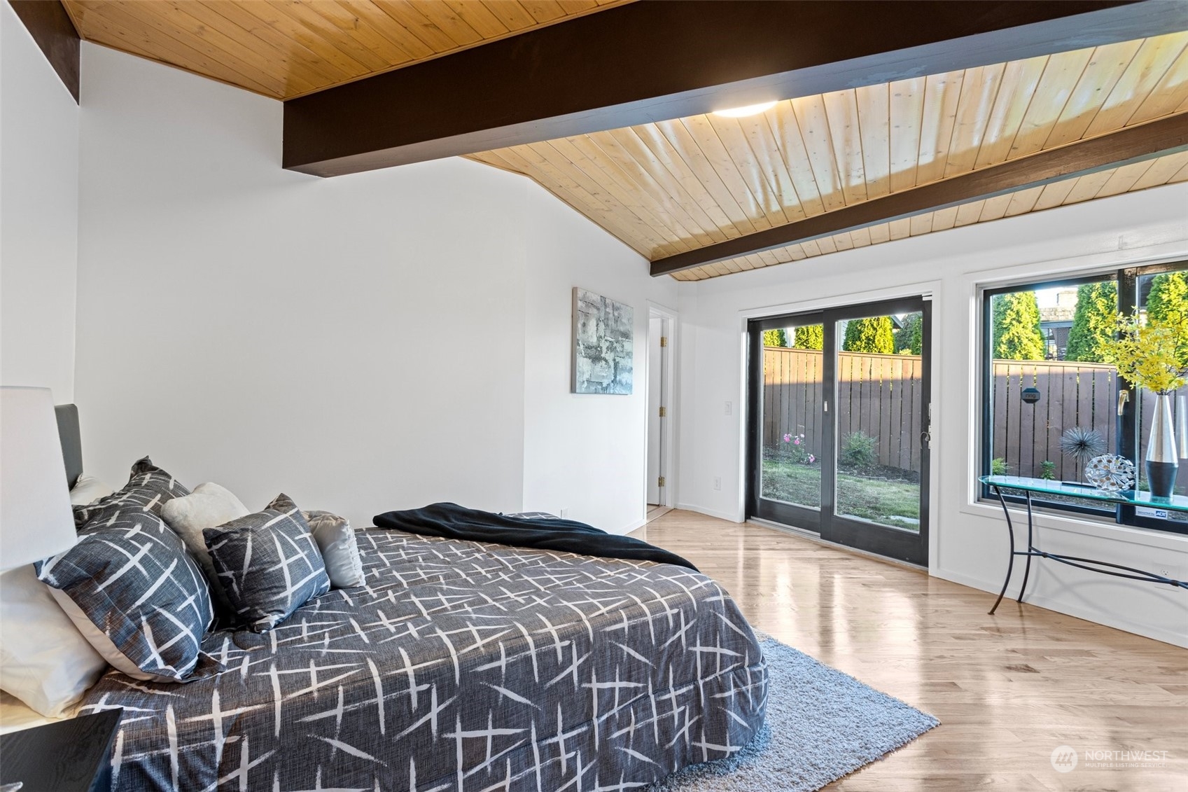 4428 140th Avenue Southeast Bellevue, WA 98006 - Photo 30 of 40 a bedroom with a bed and glass door