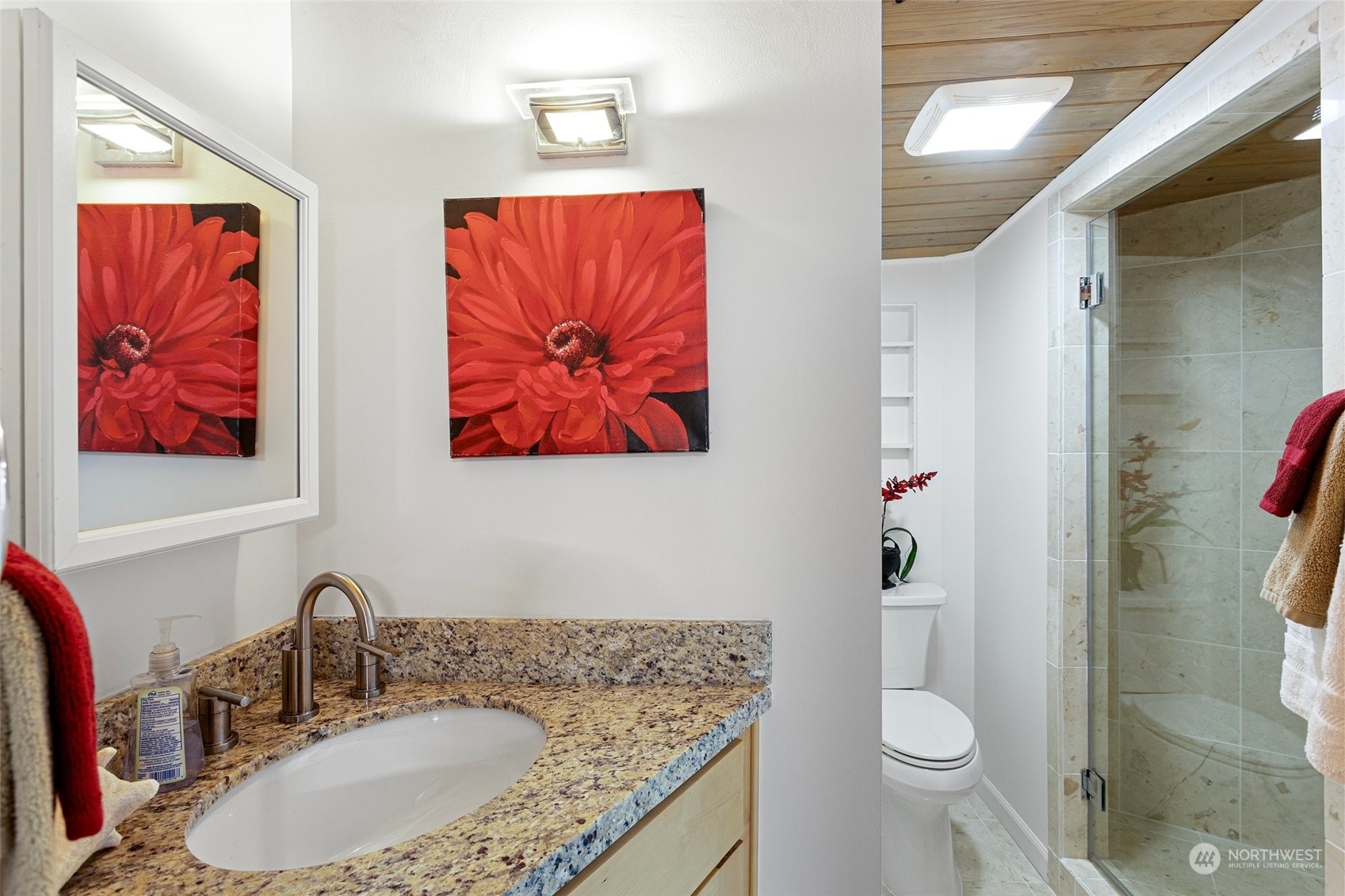 4428 140th Avenue Southeast Bellevue, WA 98006 - Photo 34 of 40 a bathroom with a granite countertop sink and a mirror