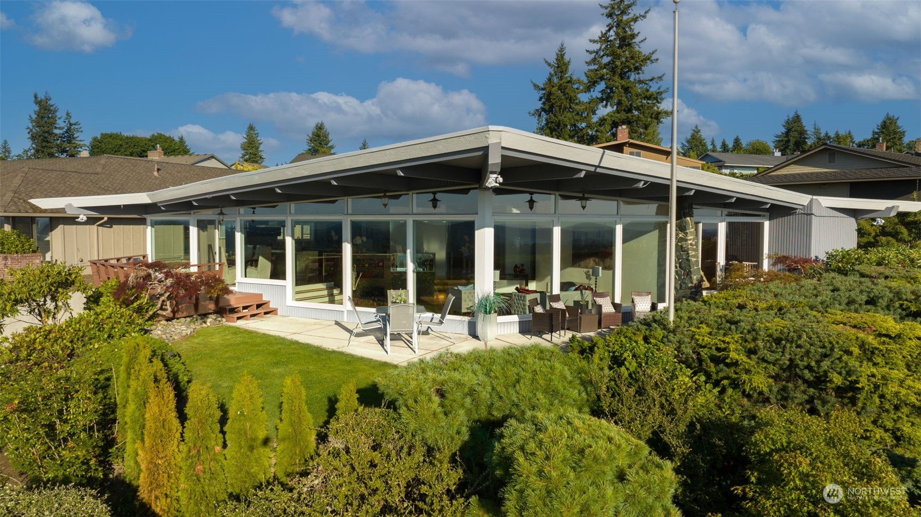 4428 140th Avenue Southeast Bellevue, WA 98006 - Photo 9 of 40 front view of house with a yard glass top table and chairs