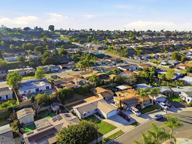 an aerial view of a house with garden space and street view