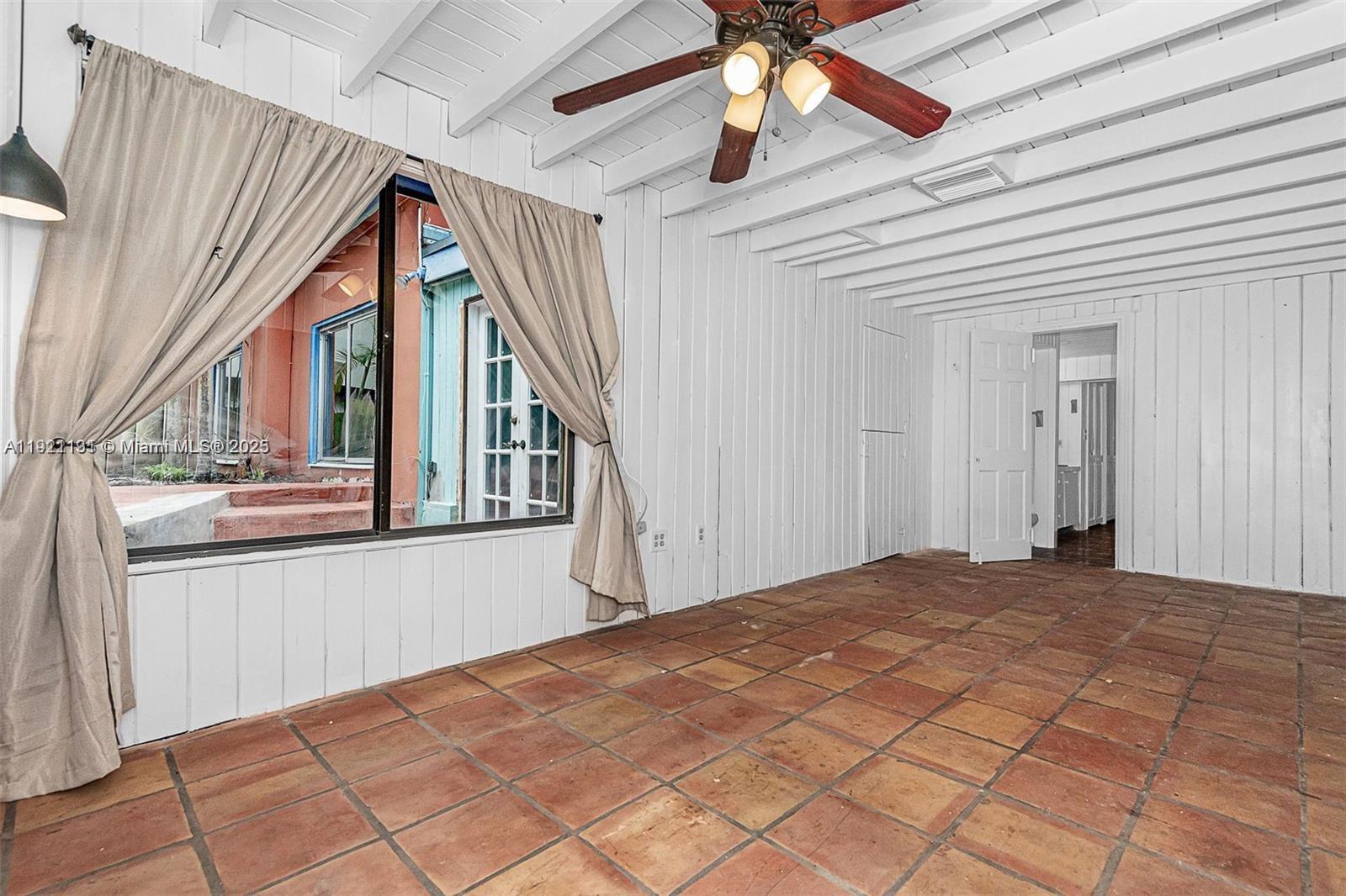 3656 Avocado Avenue Miami, FL 33133 - Photo 18 of 21 a view of empty room with wooden floor and fan