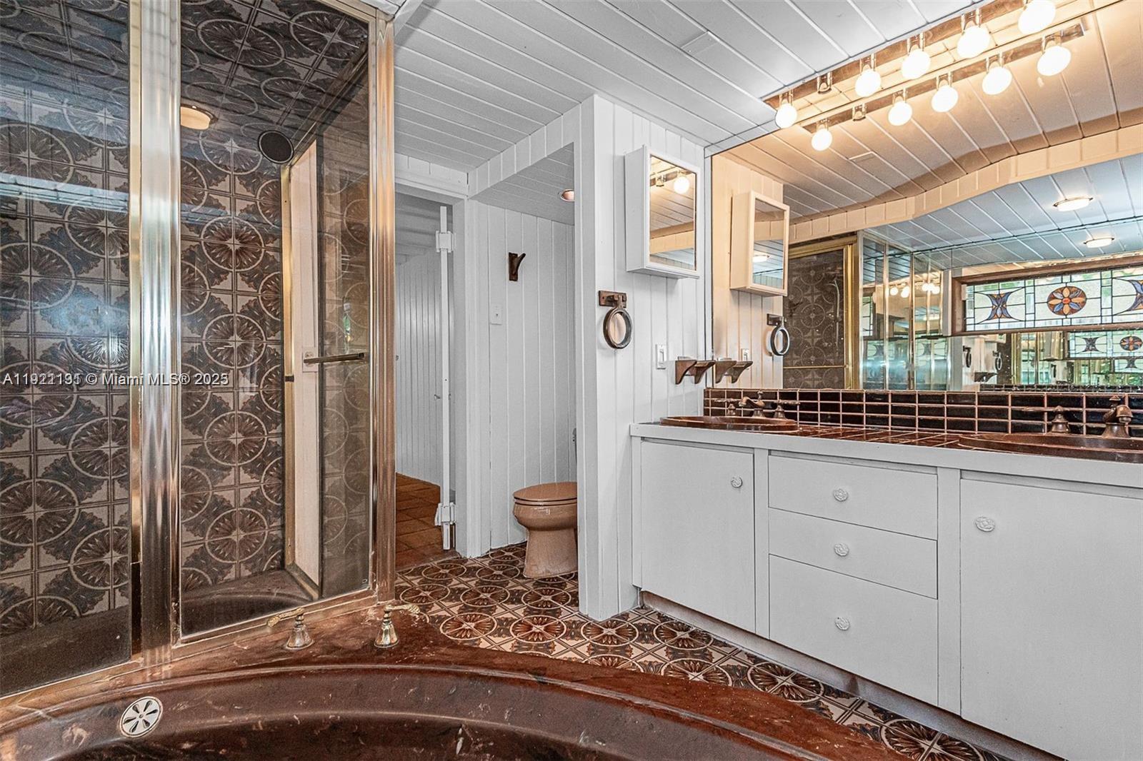 3656 Avocado Avenue Miami, FL 33133 - Photo 20 of 21 a bathroom with a granite countertop sink and a mirror