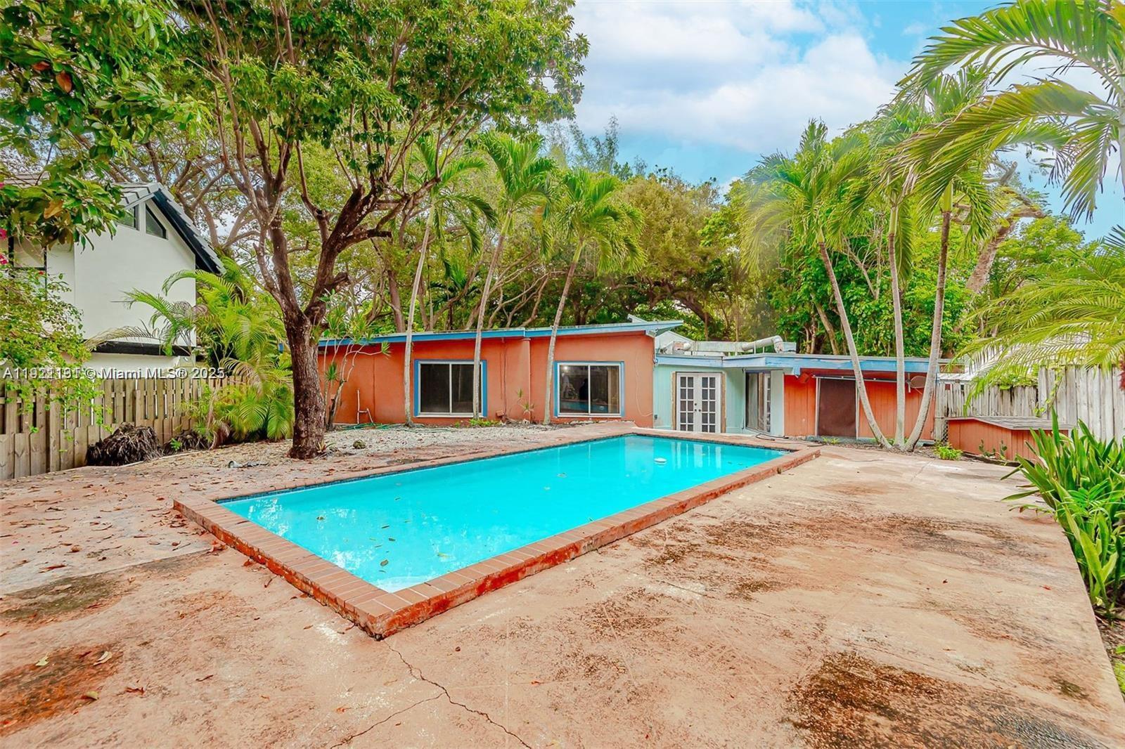 3656 Avocado Avenue Miami, FL 33133 - Photo 2 of 21 a view of a backyard with a patio and fire pit