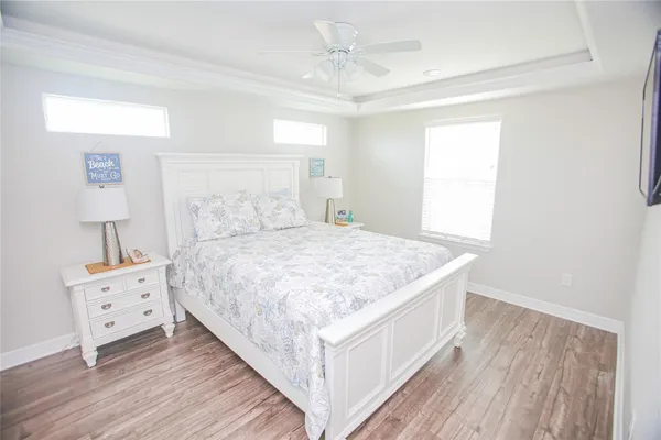a spacious bedroom with a bed and a night stand
