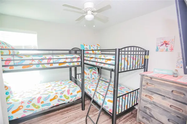 a bedroom with furniture a baby crib and a window