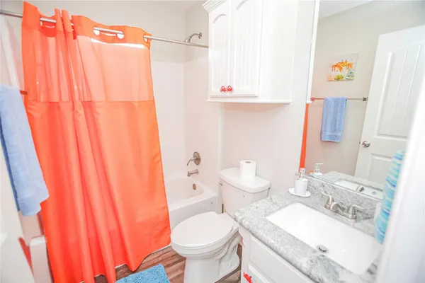 a white toilet sitting next to a bathroom sink
